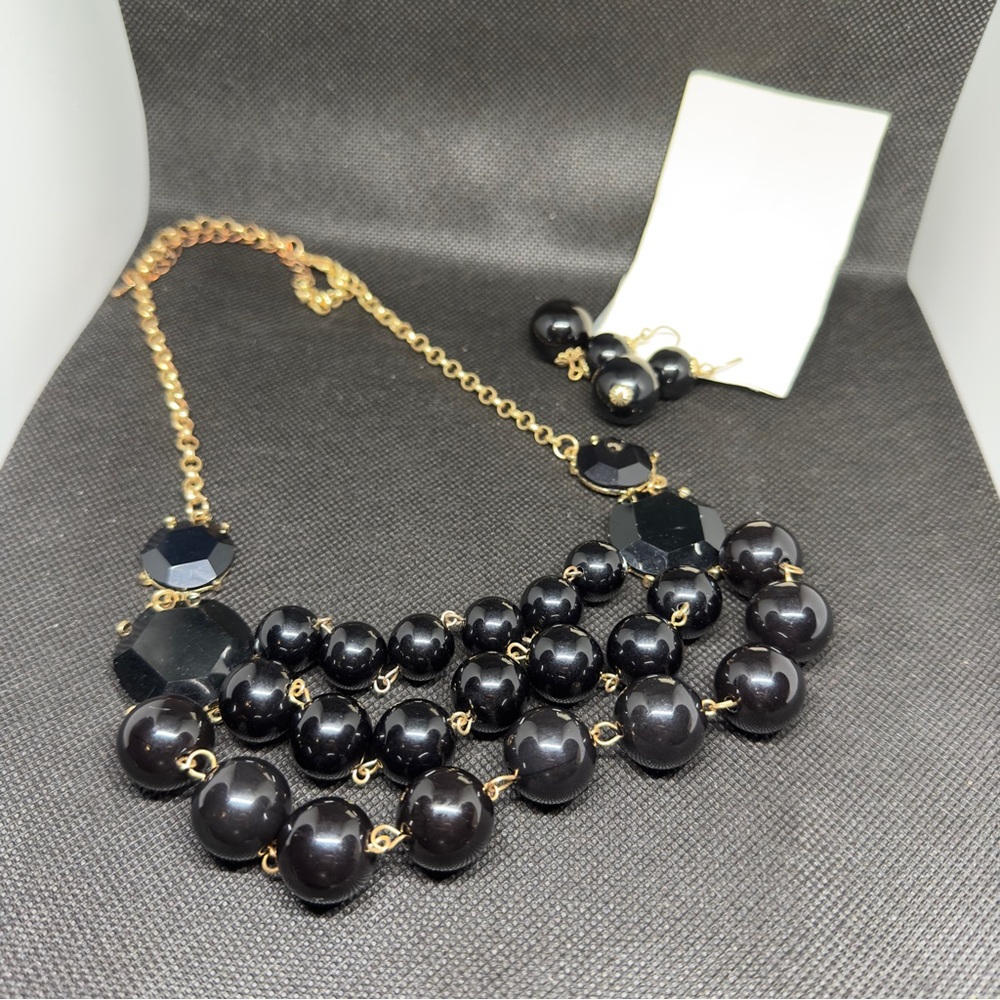 Black multi strand necklace with matching earrings